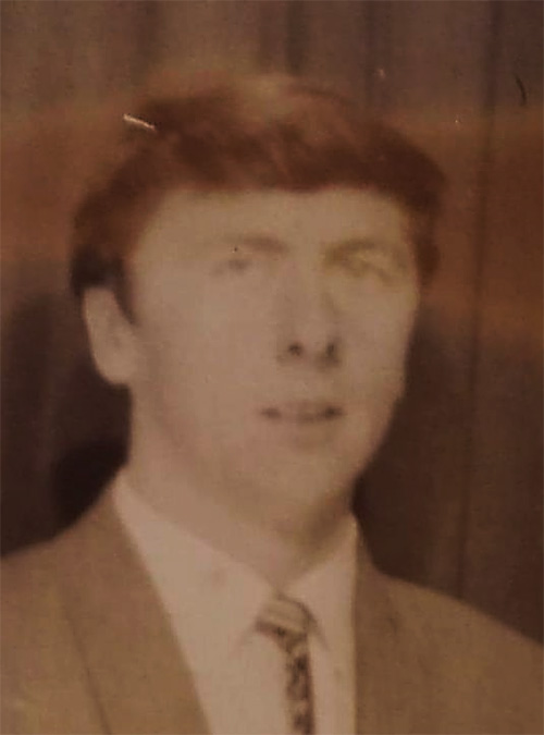 Archival image of a young man in a suit.