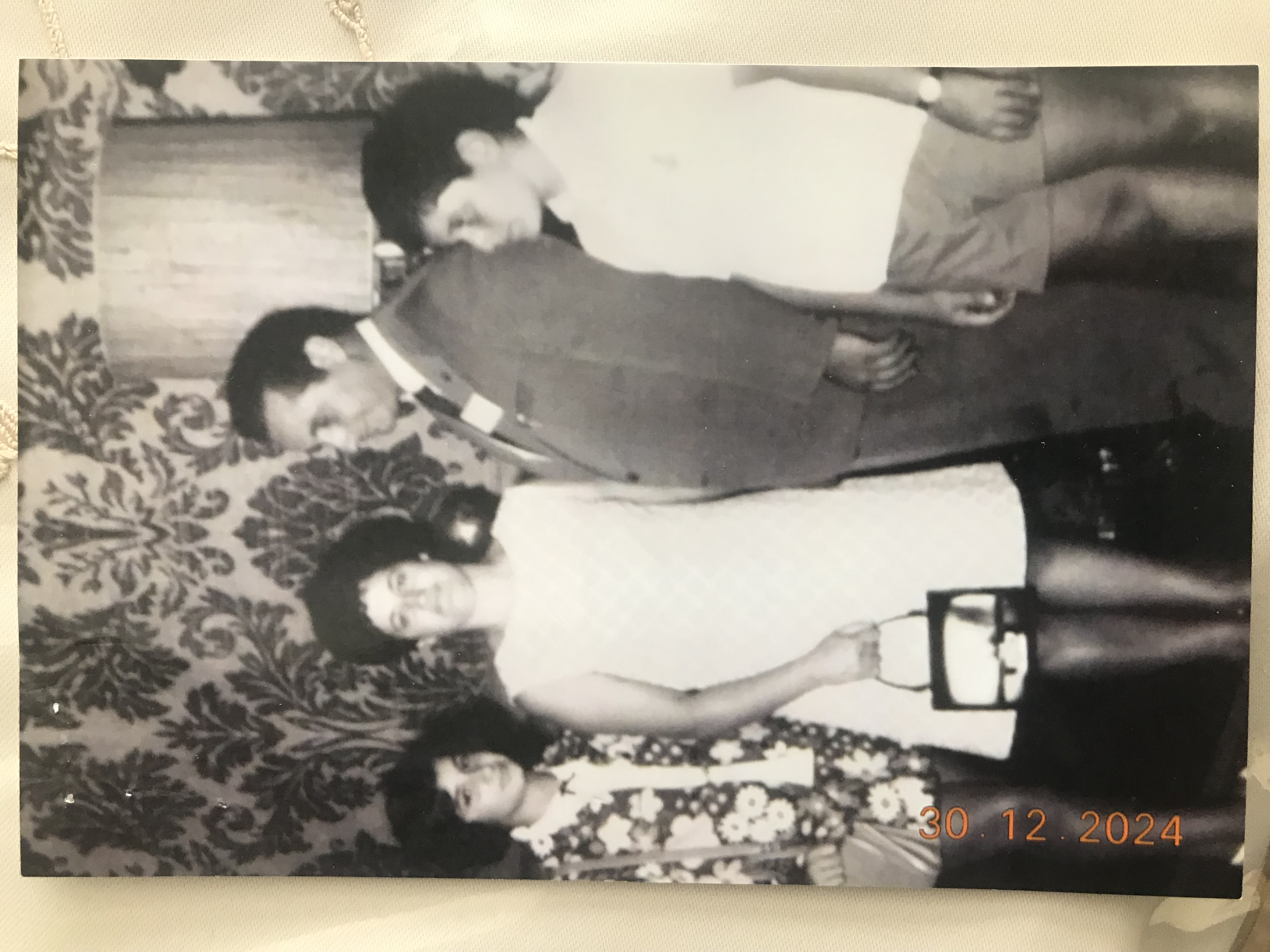 A black and white photo of an Italian family, dressed formally.