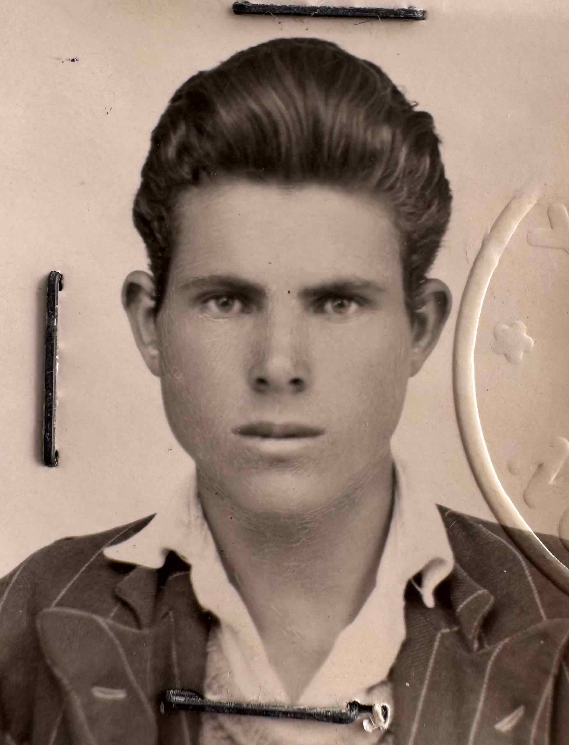 A black and white photo of a young man’s Greek passport photo.