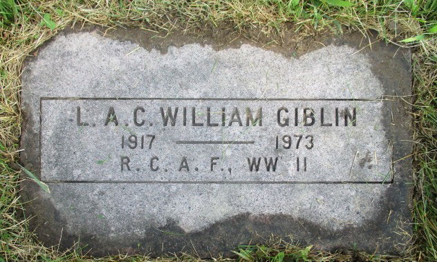 A flat gravestone in the grass engraved with William Giblin’s name, years, and service.